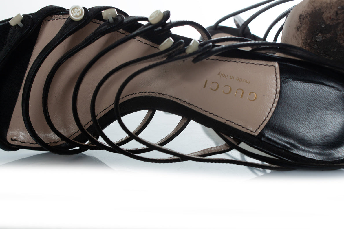 Women's Gucci black strap sandals with Gucci buttons